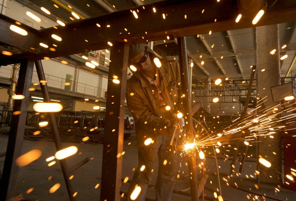 pexels-photo-10037658-10037658 A welder sparks in an industrial workshop in Rio de Janeiro, Brazil.